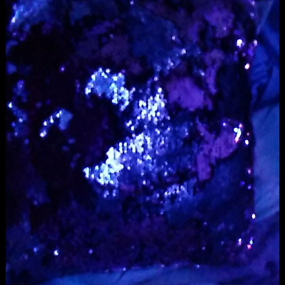 A pink and silver sequence pillow.